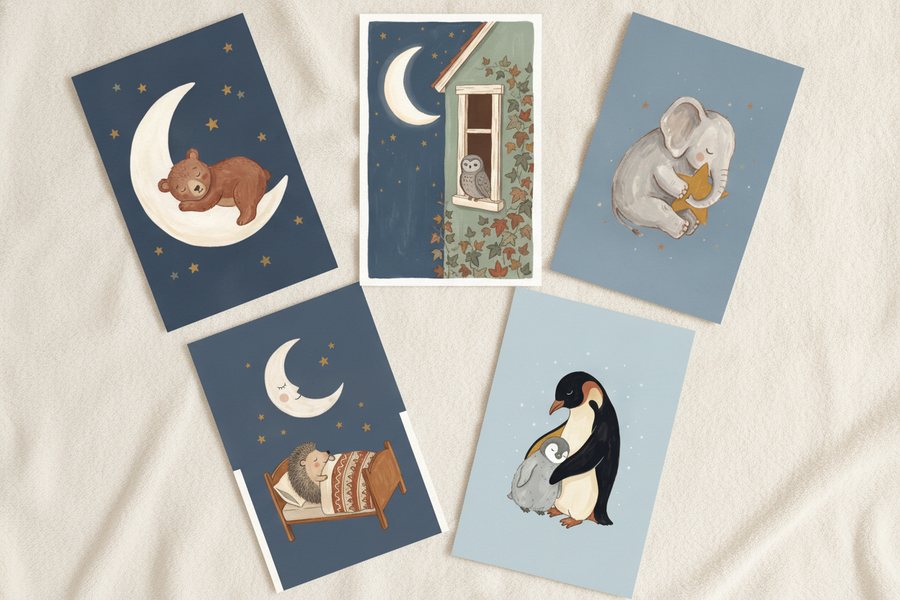 The five free bedtime prints laid out unframed on a cream blanket