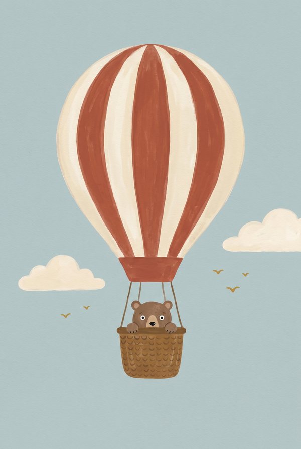 A bear riding in the basket of a red and cream striped hot air balloon